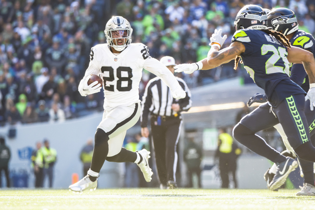 Nov 27, 2022; Seattle, Washington, USA; Las Vegas Raiders running back Josh Jacobs (28) rushes against the Seattle Seahawks during the first quarter at Lumen Field. Mandatory Credit: Joe Nicholson-USA TODAY Sports